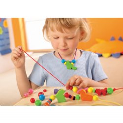 child threading beads
